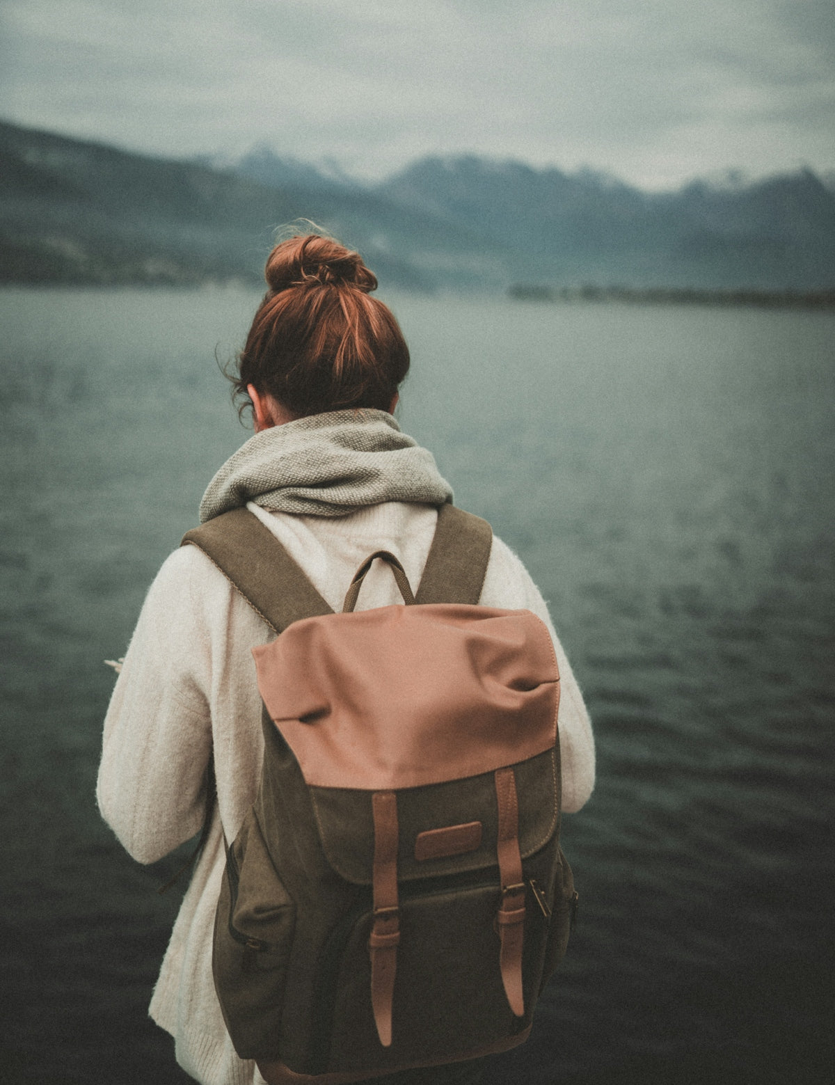 woman standing nearby calm body of water ]