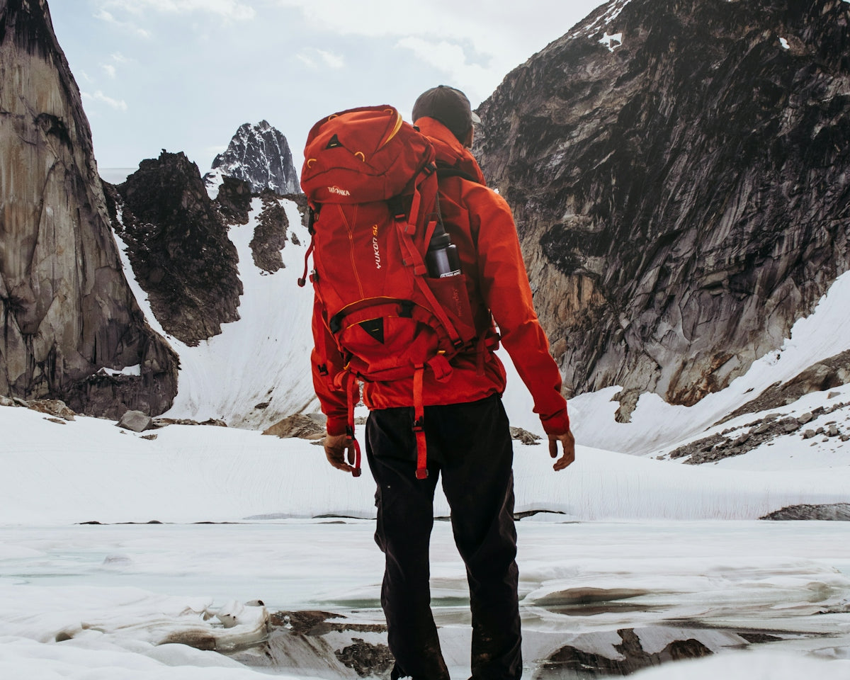 man carrying hiking backpack