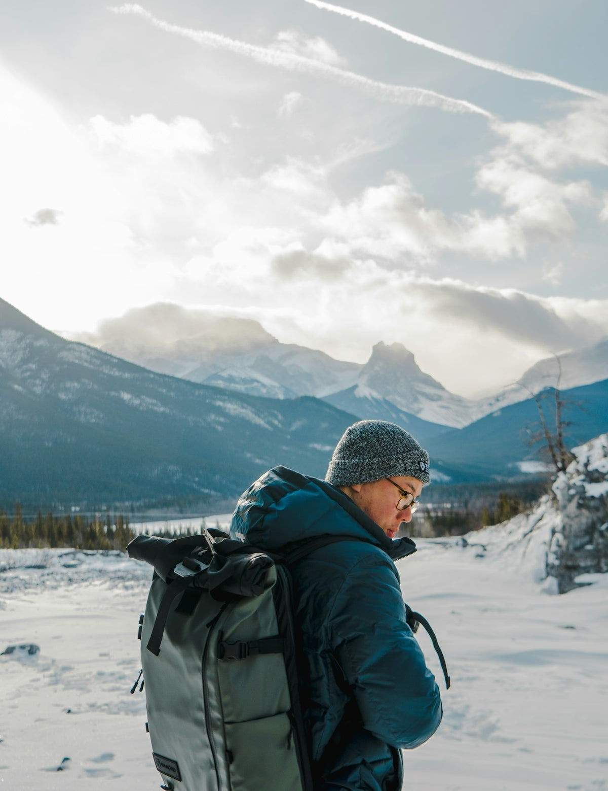 man wearing black coat carrying backpack