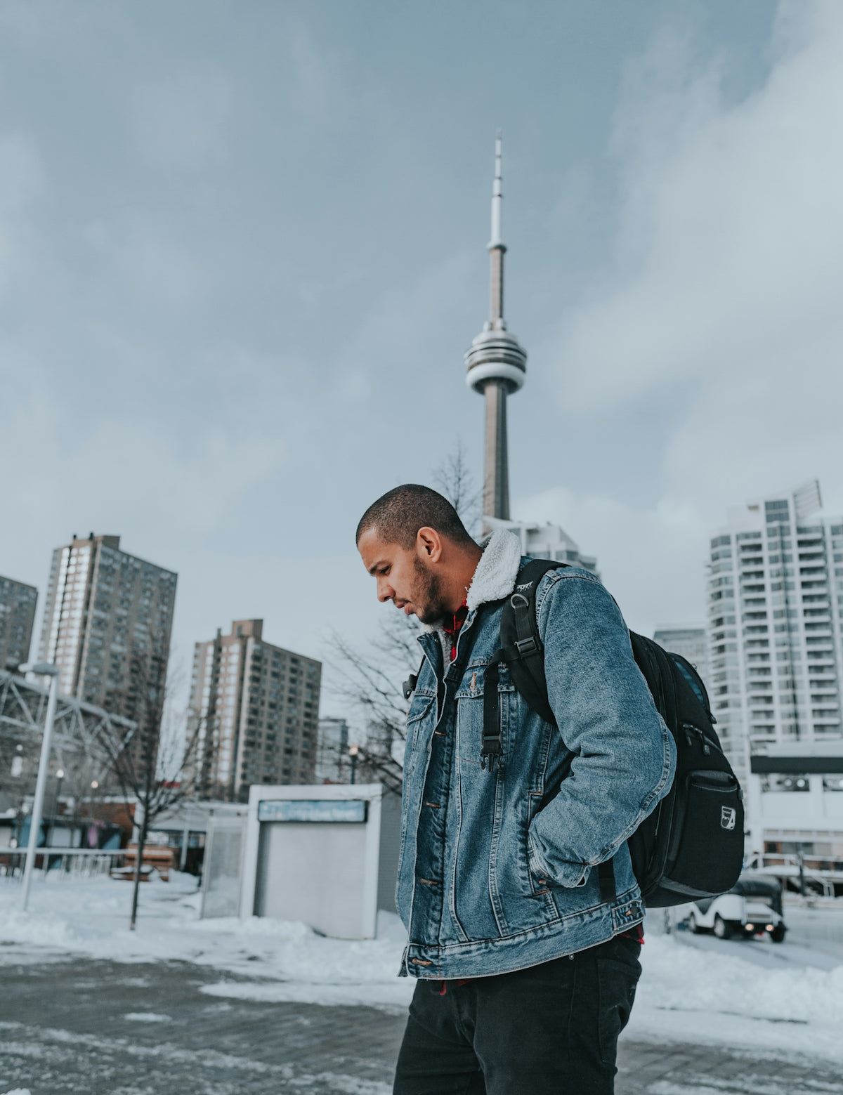 a man with a backpack standing in the snow