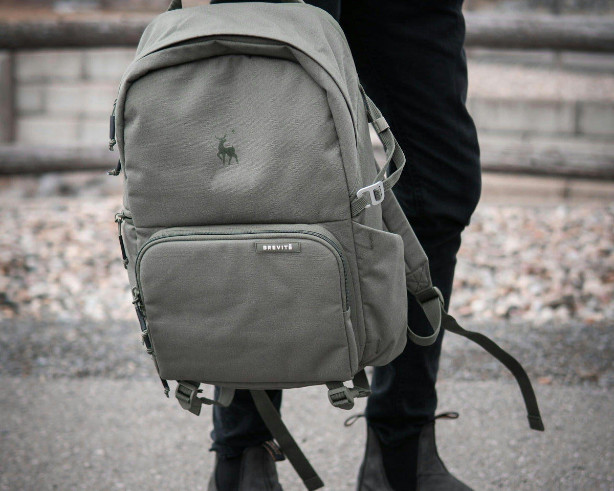 person in black jacket carrying gray backpack