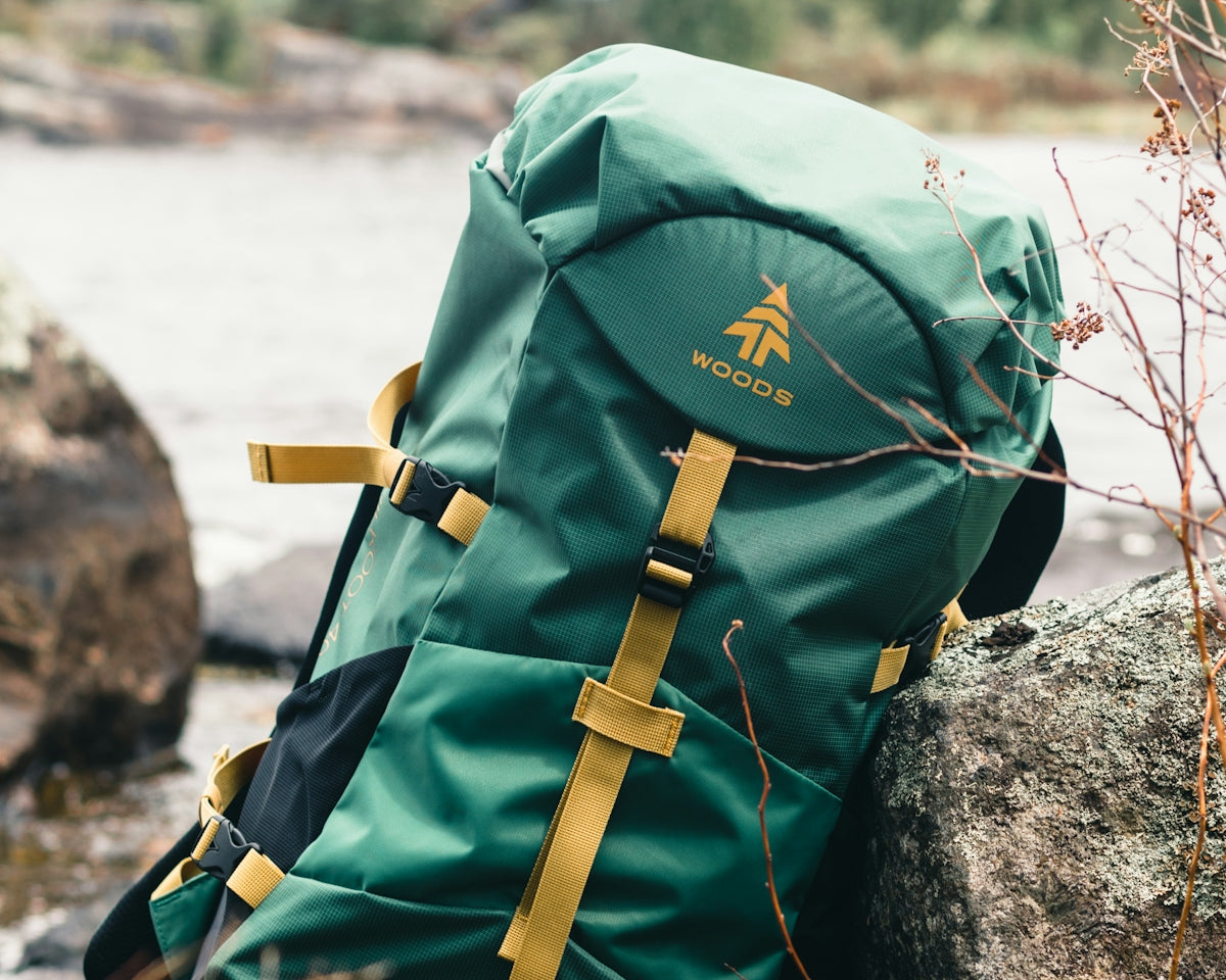 green and brown backpack on rock