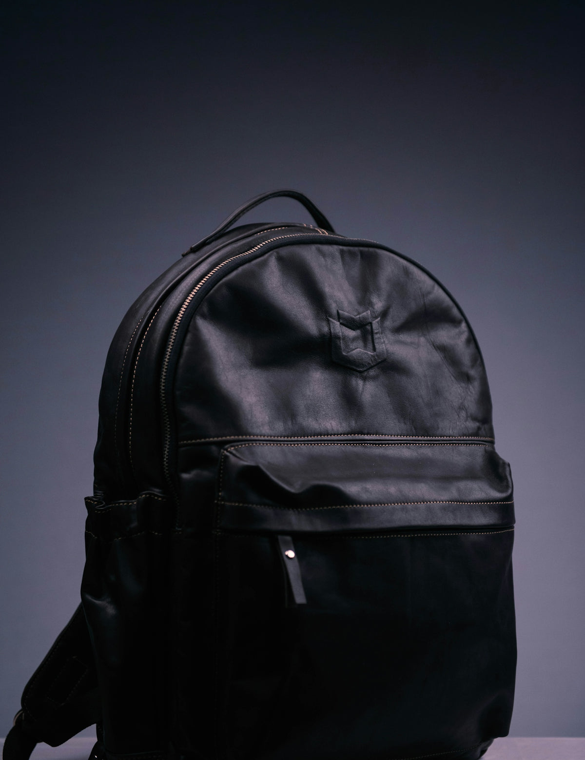 black nike backpack on purple surface
