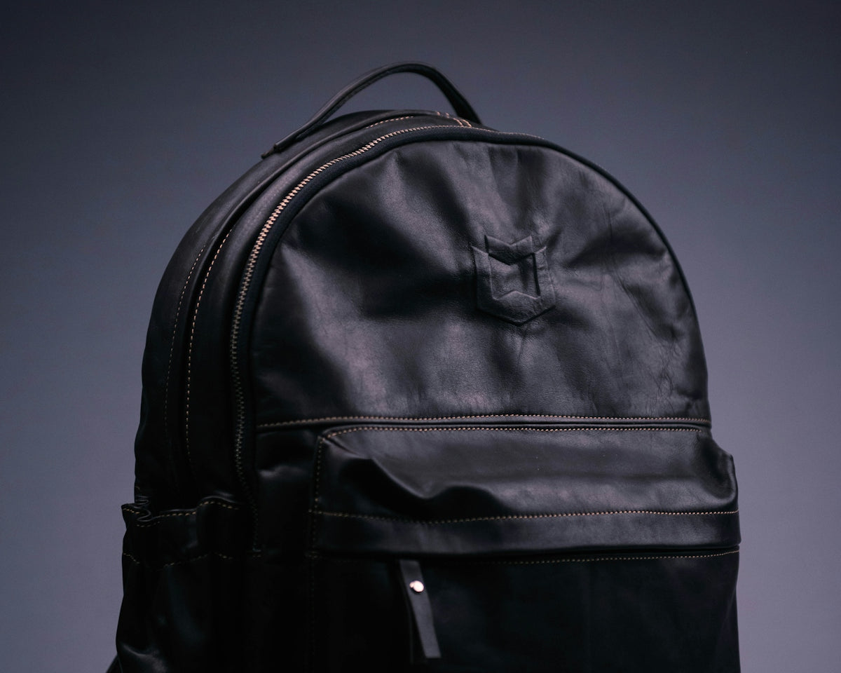 black nike backpack on purple surface