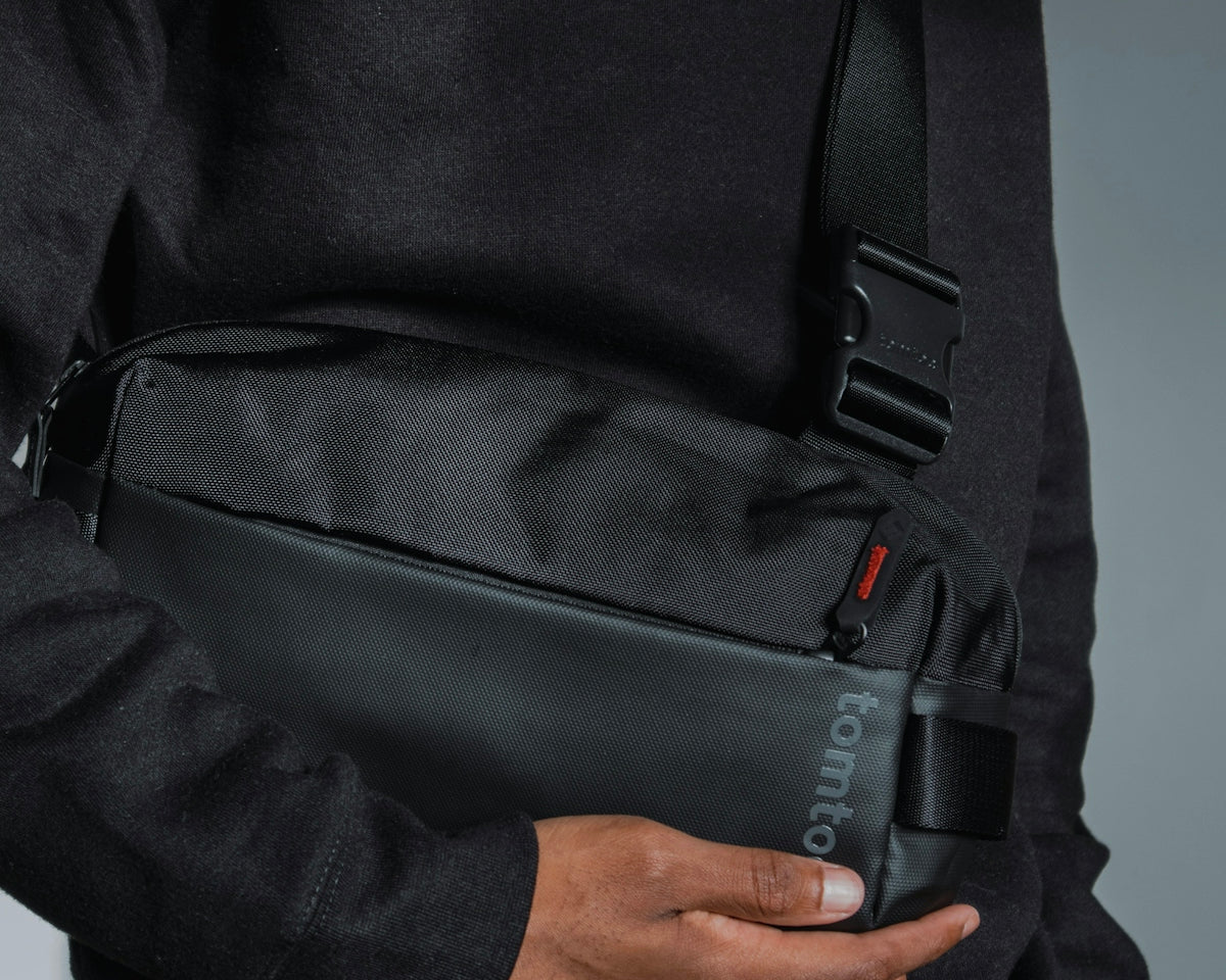 a man holding a black bag in his hands