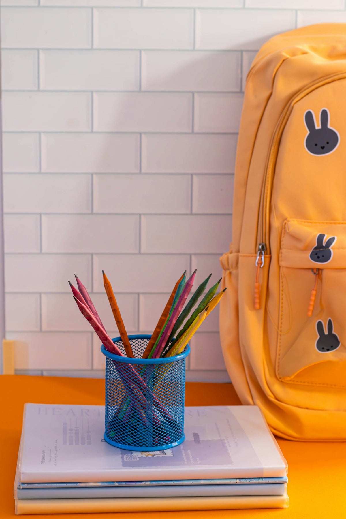 A yellow backpack sitting on top of a table