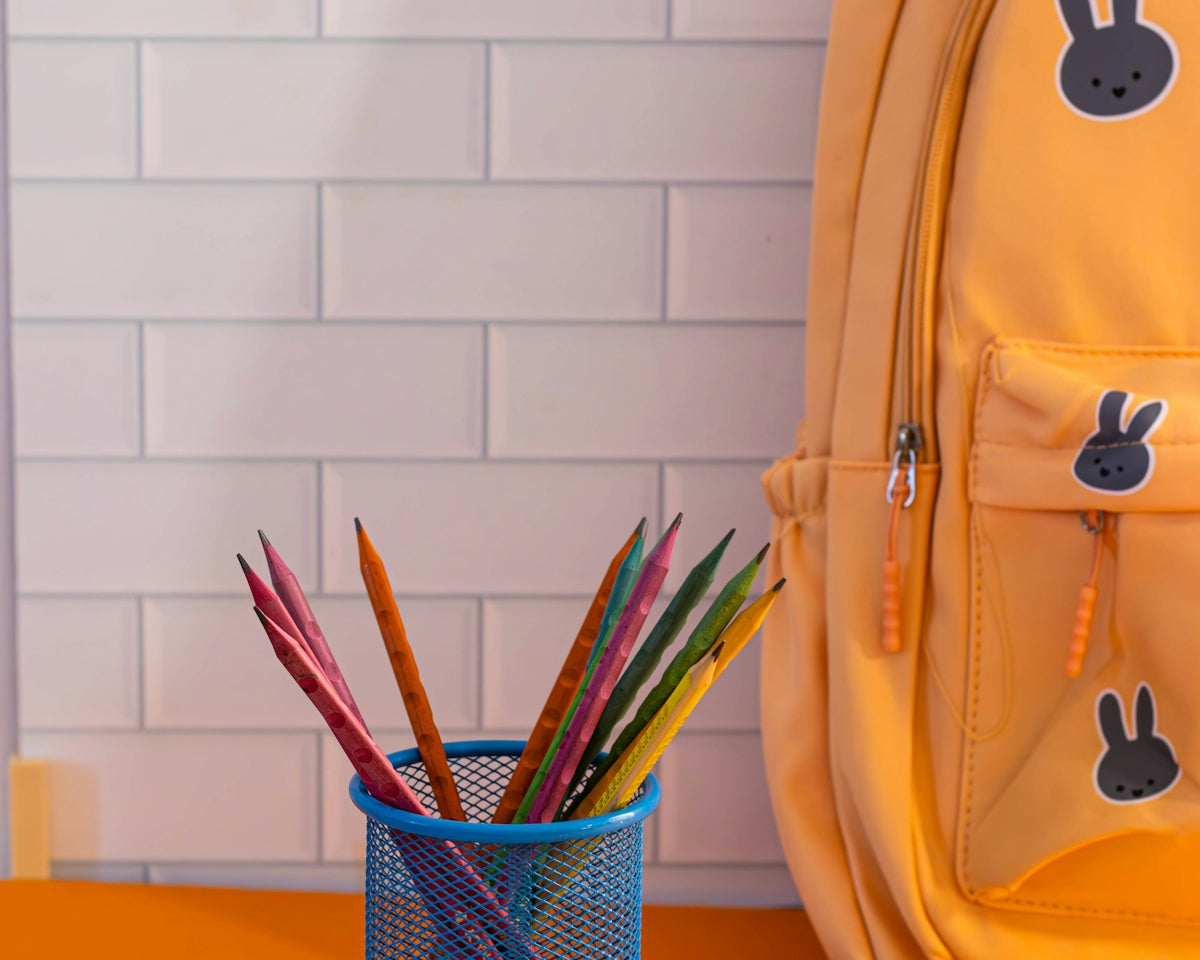 A yellow backpack sitting on top of a table
