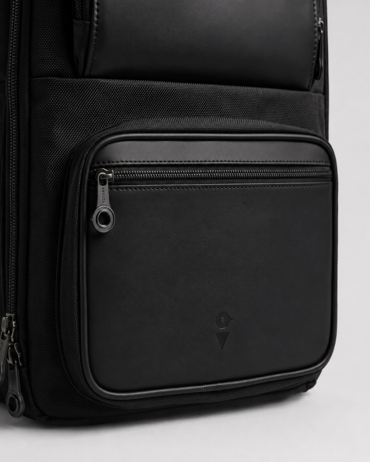 Lower front zip pocket with embossed VENQUE logo