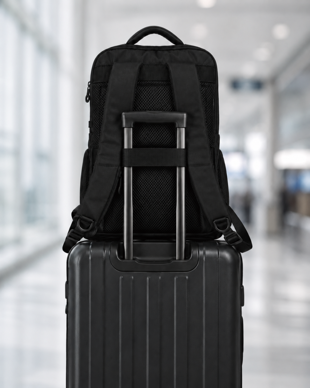 Envoy Business Pack on a carry-on suitcase using the luggage pass-through