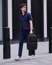 Man walking with the Envoy Business Pack carried by the handle