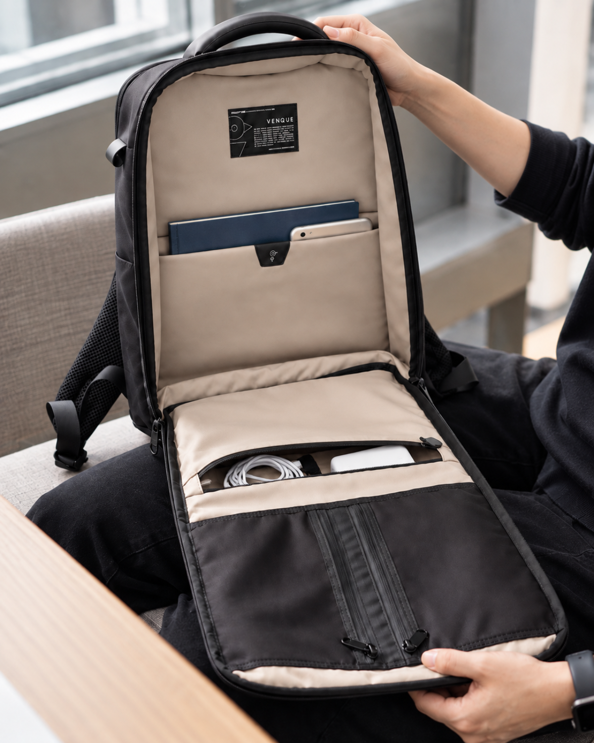 Envoy Business Pack interior loaded with a notebook, tablet, cables and power bank