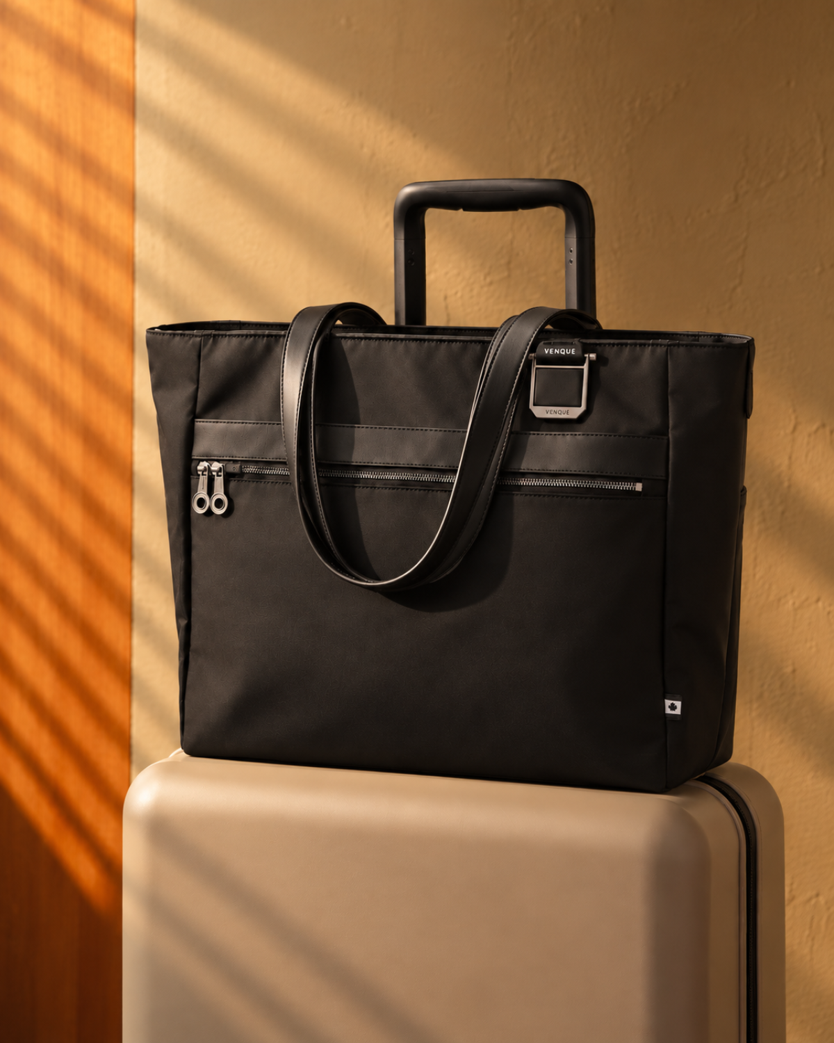 Voya Executive Tote travelling on a carry-on suitcase
