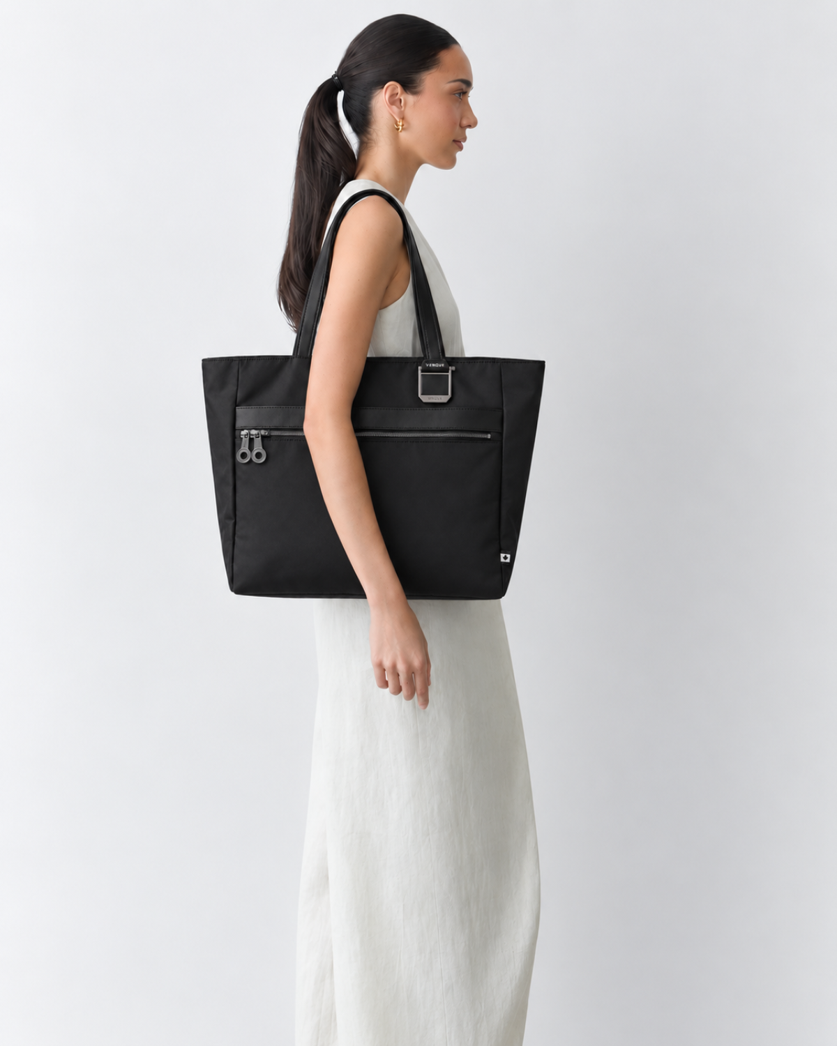 Model carrying the Voya Executive Tote, profile view